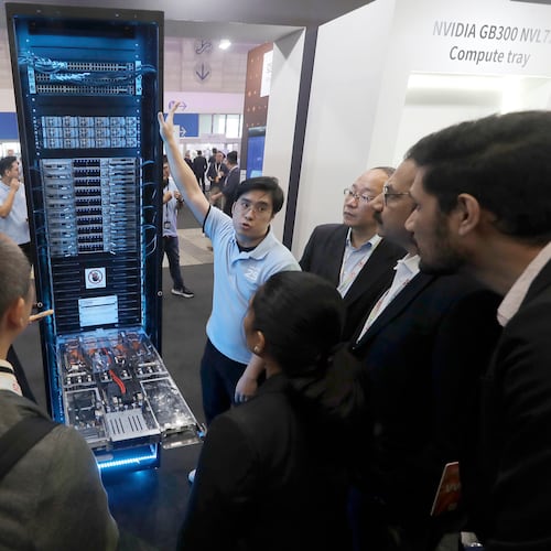 FILE - Visitors listen to the introduction of NVIDIA GB300 NVL72 AI server during the Hon Hai Tech Day (HHTD 25) at the Nangang Exhibition Center in Taipei, Taiwan, Nov. 21, 2025. (AP Photo/Chiang Ying-ying, File)