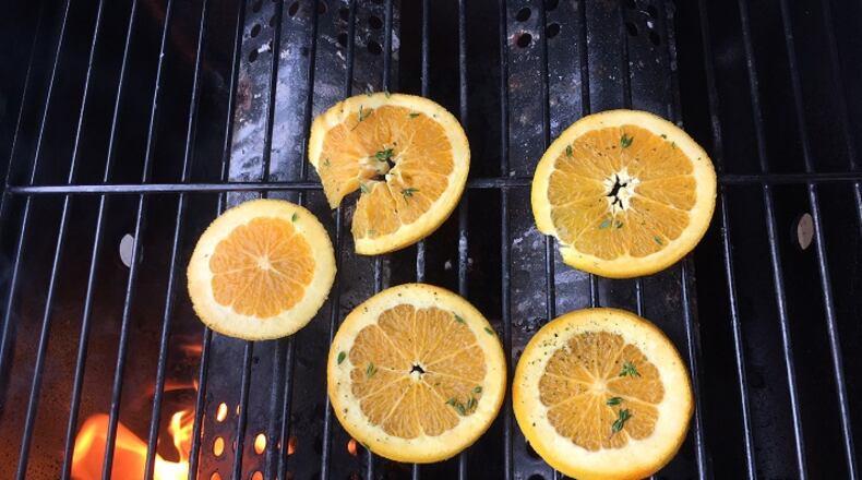 Thick slices of orange are marinated in bourbon, honey, thyme and black pepper before they are slapped on the grill for a few minutes of high heat.The charred slices are then muddled and shaken with yet more honey, bourbon and orange liqueur before the infused liquid is topped with chilled beer. (Lee Svitak Dean/Minneapolis Star Tribune /TNS)