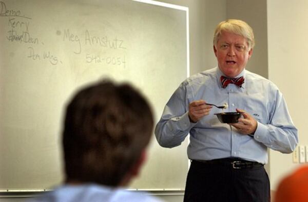Michael Adams eats ice cream between lectures on Aug. 31, 2004. The school president long taught freshman seminars on presidential politics. (AJC file)