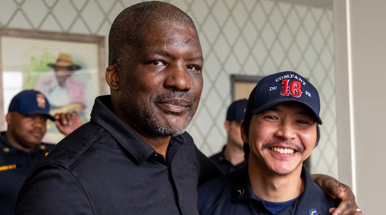 Portrait of Fulton County Fire Department Lieutenant Mark Quick (left) stands with Nishan Mu, the DeKalb County Fire Rescue member that helped save his life. PHIL SKINNER FOR THE ATLANTA JOURNAL-CONSTITUTION