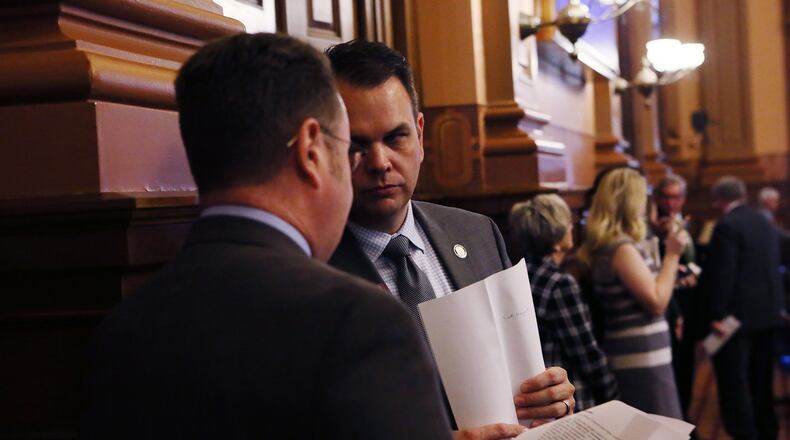 Jan. 10, 2017 - Atlanta - Rep. Christian Coomer (R - Cartersville) (right), Majority Whip, and Rep. Kevin Tanner (R - Dawsonville) discuss legislation on the House floor. The house meets for the second day of this year’s legislative session. BOB ANDRES /BANDRES@AJC.COM