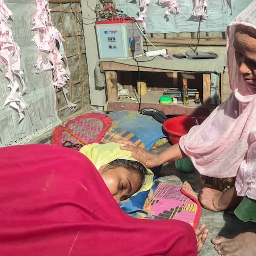 Majuma Khatun, the mother of Rahela Begum, a Rohingya survivor, comforts her at their shelter after she was rescued on April 9, 2026 from a capsized boat, at a refugee camp in Cox's Bazar, Bangladesh, Wednesday, April 15, 2026. (AP Photo/Suzauddin Rubel)