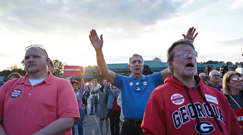 Supporters of Republican U.S. Senate hopeful Herschel Walker pray Thursday as Alveda King (not pictured), a niece of the Rev. Martin Luther King Jr., leads them in prayer before Walker arrives during a rally in Smyrna. (Hyosub Shin / Hyosub.Shin@ajc.com)