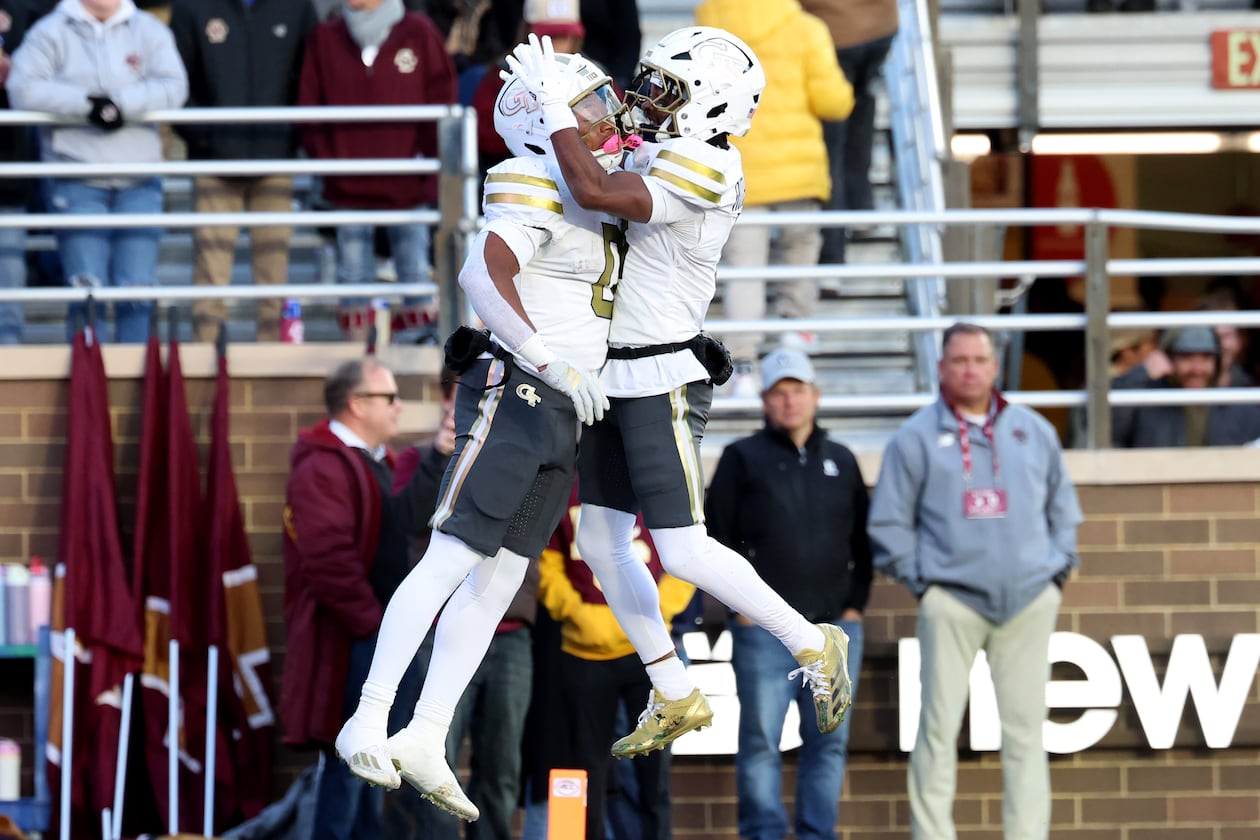 Georgia Tech running back Malachi Hosley (left) ran for 107 yards and a touchdown, while wide receiver Malik Rutherford (right) had 121 yards receiving. Georgia Tech narrowly escaped a Boston College upset bid with a 36-34 win. (Mark Stockwell/AP)