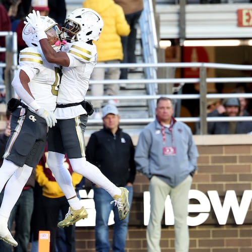 Georgia Tech running back Malachi Hosley (left) ran for 107 yards and a touchdown, while wide receiver Malik Rutherford (right) had 121 yards receiving. Georgia Tech narrowly escaped a Boston College upset bid with a 36-34 win. (Mark Stockwell/AP)
