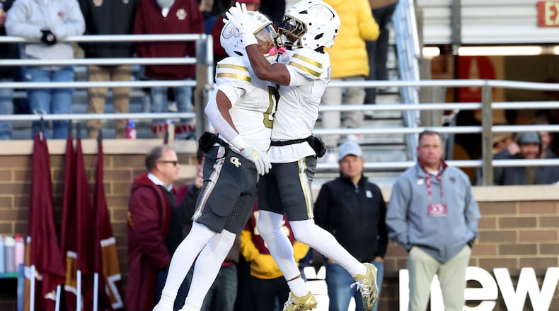 Georgia Tech running back Malachi Hosley (left) ran for 107 yards and a touchdown, while wide receiver Malik Rutherford (right) had 121 yards receiving. Georgia Tech narrowly escaped a Boston College upset bid with a 36-34 win. (Mark Stockwell/AP)