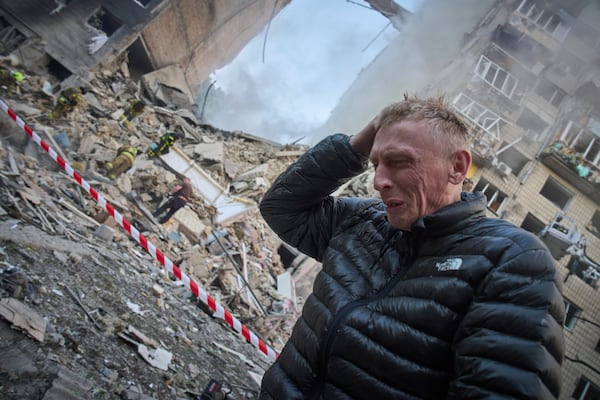 A resident reacts after a Russian missile hit a multi-storey apartment during Russia's massive missile and drone air attack in Kyiv, Ukraine, Tuesday, June 17, 2025. (AP Photo/Efrem Lukatsky)