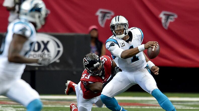Carolina Panthers quarterback Cam Newton is brought down by Atlanta Falcons defensive end Dwight Freeney during the second quarter in the Georgia Dome Sunday October 2, 2016. BRANT SANDERLIN/BSANDERLIN@AJC.COM