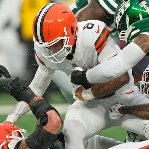 Cleveland Browns quarterback Dillon Gabriel (8) is sacked by New York Jets linebacker Quincy Williams, bottom right, in the second half of an NFL football game Sunday, Nov. 9, 2025, in East Rutherford, N.J. (AP Photo/Yuki Iwamura)