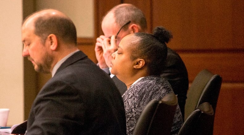 Erica White, center, takes a deep breath during the start of her trial at Cobb County Superior Court, Monday, January 22, 2018. Erica Claudette White is on trial for the death of her 2-year-old son.