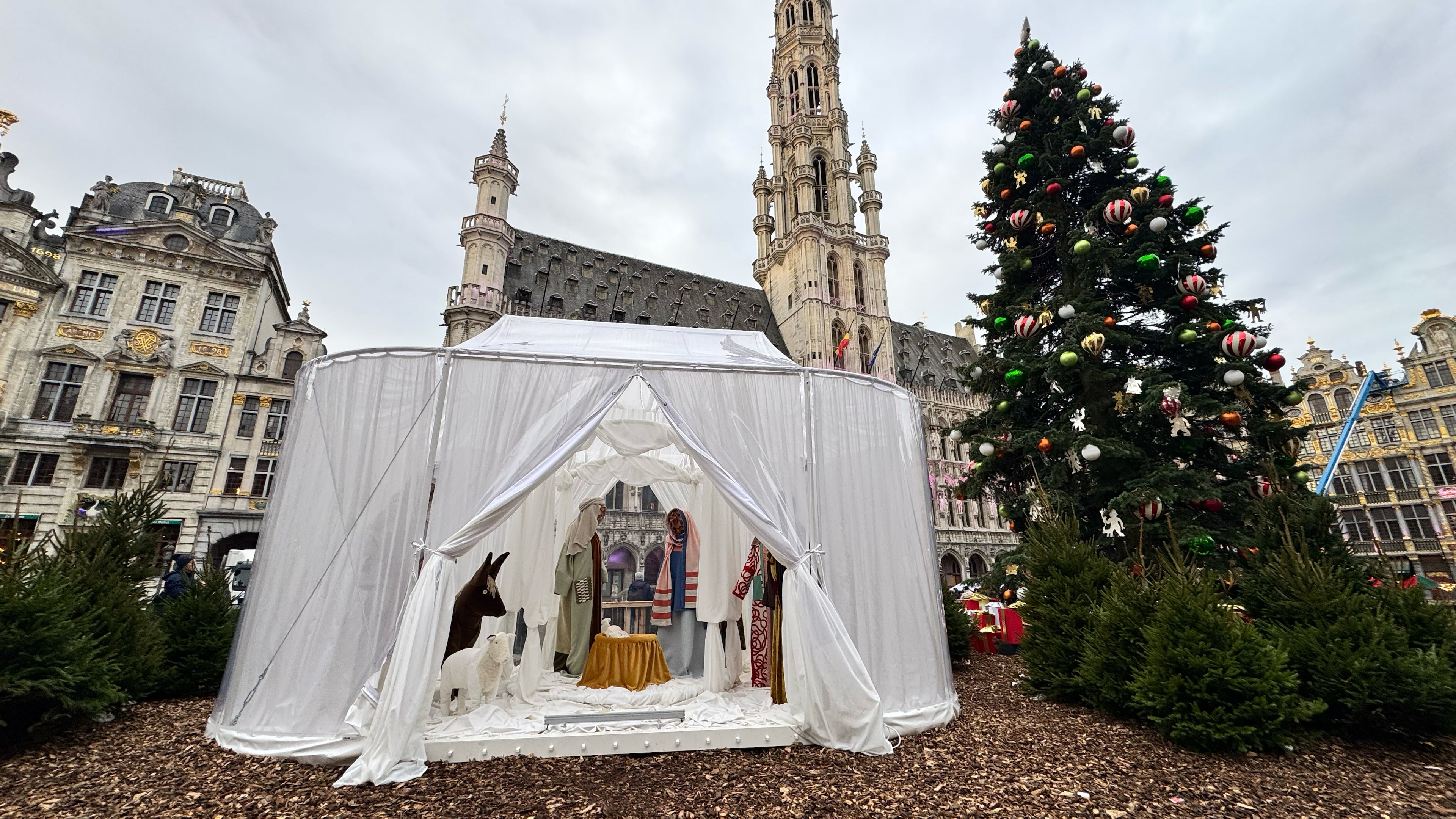A Nativity scene containing characters with cloth faces, by Belgian artist Victoria-Maria Geyer, is displayed in a white tent in Brussels, Monday, Dec. 1, 2025. (AP Photo/Sylvain Plazy)