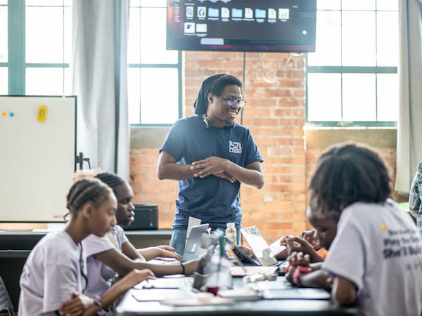 A Black Girls Code camp instructor teaches girls how to program their own game using GDScript, a coding language similar to Python. (Courtesy of Black Girls Code)