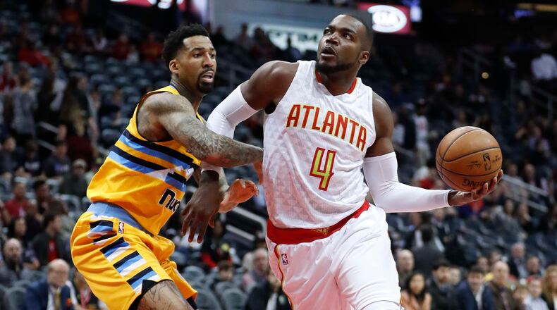 Atlanta Hawks forward Paul Millsap (4) drives against Denver Nuggets forward Wilson Chandler (21) during the first half of an NBA basketball game Wednesday, Feb. 8, 2017, in Atlanta. (AP Photo/John Bazemore)