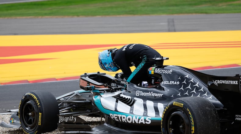 Mercedes driver George Russell of Britain gets out of his car after going off the track during the Formula One Grand Prix at the Spa-Francorchamps racetrack in Spa, Belgium, Sunday, July 19, 2026. (AP Photo/Geert Vanden Wijngaert)