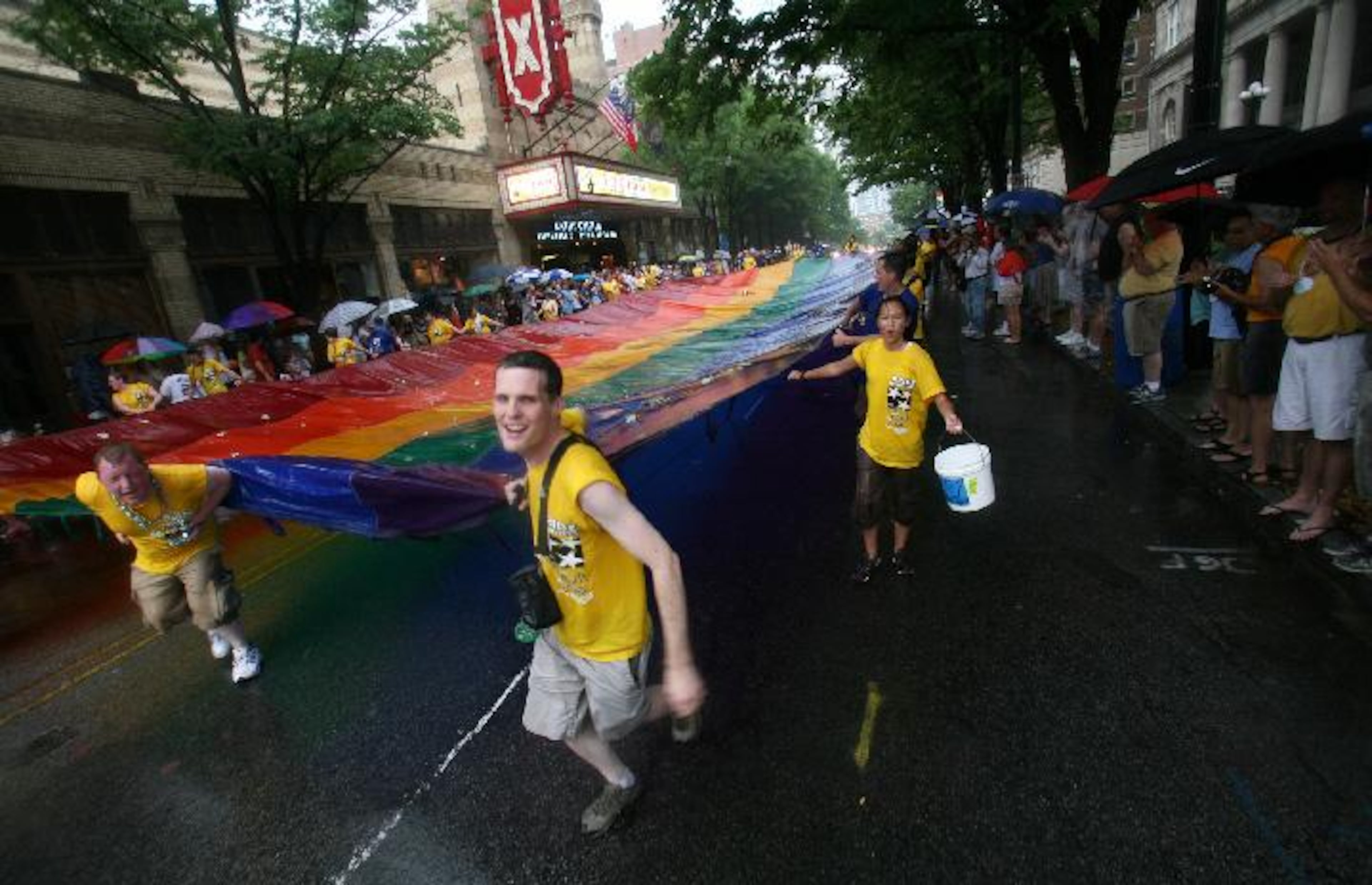 In this file photo, volunteers carry a large gay pride flag along Peachtree Street in front of the Fox Theatre on July 06, 2008. A large crowd gathered along Peachtree Street for the Atlanta Pride Parade.