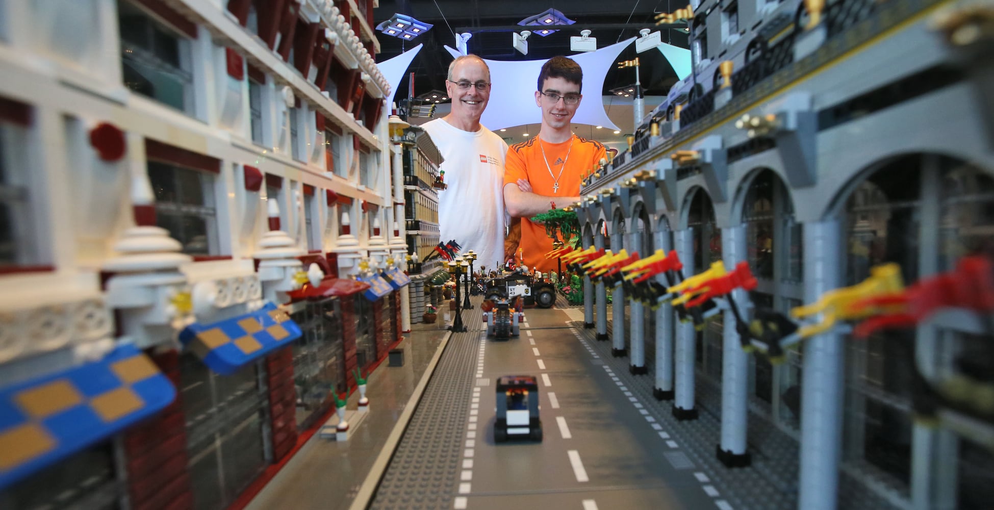 Father and son build giant Lego cityscape