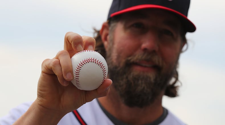 Braves pitcher R.A. Dickey shows off his knuckleball grip during photo day at spring training. Curtis Compton/ccompton@ajc.com