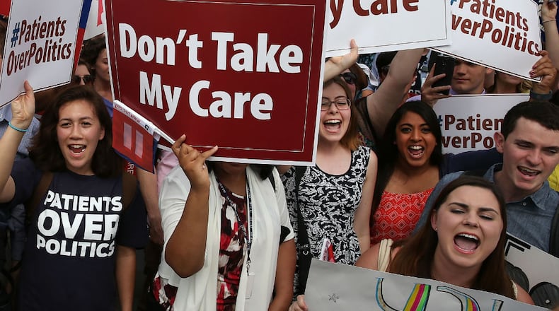People celebrate in front of the U.S. Supreme Court after the ruling was announced on the Affordable Care Act on June 25, 2015 in Washington, DC. The high court ruled that the Affordable Care Act may provide nationwide tax subsidies to help poor and middle-class people buy health insurance. (Mark Wilson/Getty Images)
