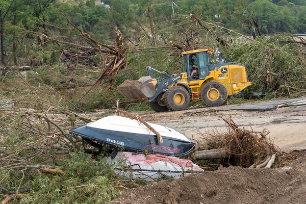 Crews work to clear debris from the Cade Loop bridge along the Guadalupe River on Saturday, July 5, 2025, in Ingram, Texas. (AP Photo/Rodolfo Gonzalez)