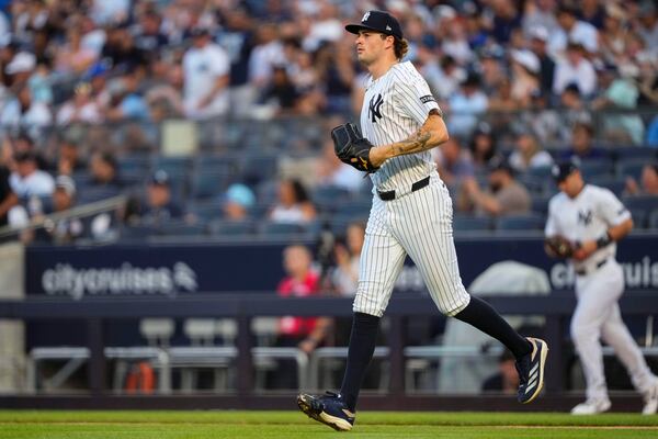 New York Yankees pitcher Cam Schlittler (31) walks onto the field during the first inning of a baseball game against the Seattle Mariners, Wednesday, July 9, 2025, in New York. (AP Photo/Yuki Iwamura)