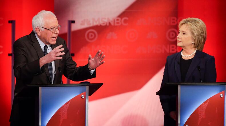 Democratic presidential candidate, Hillary Clinton listens as Democratic presidential candidate, Sen. Bernie Sanders, I-Vt, answers a question during a Democratic presidential primary debate hosted by MSNBC at the University of New Hampshire Thursday, Feb. 4, 2016, in Durham, N.H. (AP Photo/David Goldman)