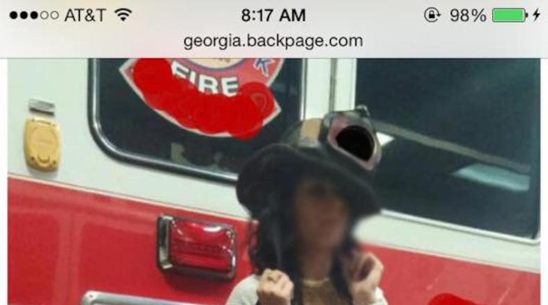 The AJC has obscured the woman’s face in this photo to protect her identity. The emblems and identifiers of the Atlanta Fire Department on the truck already had been obscured when the AJC received the photo. Credit: PHOTO ILLUSTRATION