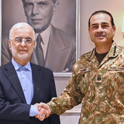 In this photo released by the Inter Services Public Relations, Iran's Interior Minister Eskandar Momeni, left, shakes hand with Pakistan's Army Chief Field Marshal Asim Munir prior to their meeting in Rawalpindi, Pakistan, Tuesday, July 21, 2026. (Inter Services Public Relations via AP)