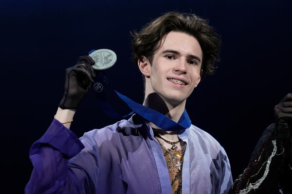 Silver medalist Mikhail Shaidorov, of Kazakhstan, holds his medal during a ceremony for men's free skating at the figure skating world championships, Saturday, March 29, 2025, in Boston. (AP Photo/Charles Krupa)