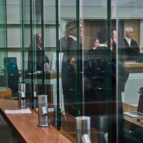 The defendant covering his face in the court during a trial against an online predator network of men accused of using chat groups to share tips on how to drug and rape women, in Berlin, Germany, Wednesday, July 8, 2026. (AP Photo/Ebrahim Noroozi)