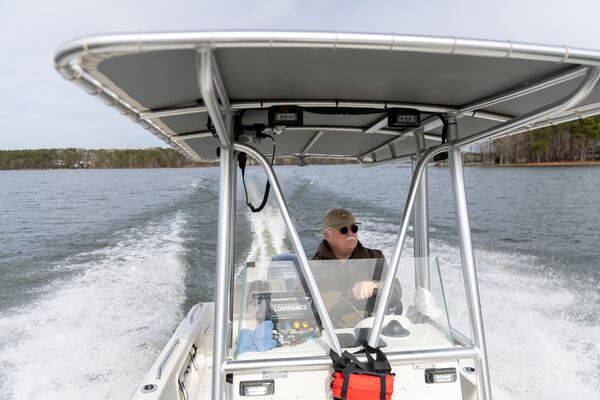 Putnam County Sheriff Howard Sills steers a boat on Lake Oconee in Eatonton in the search for Spelman College instructor Joycelyn Nicole Wilson and private school coach Gary Jones on Thursday, Feb. 13, 2025. (Arvin Temkar / AJC)