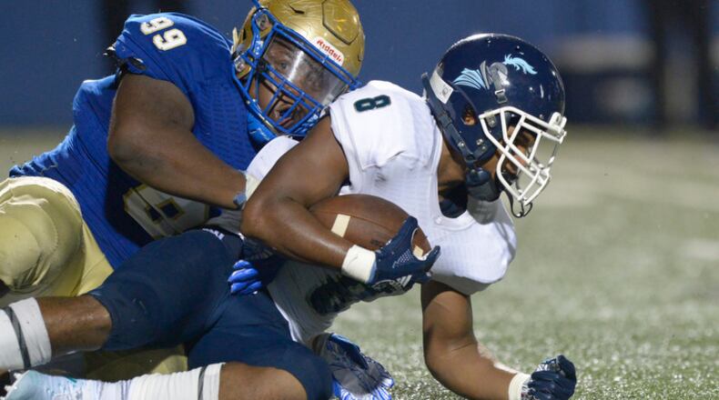 McEachern junior DE Jamil Burroughs (99) tackles Cedar Grove senior Robert Jones III in the second half of their game Friday, September 7, 2018 at McEachern High School . PHOTO/Daniel Varnado