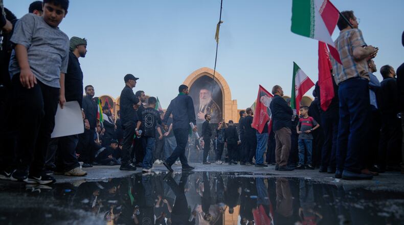 Mourners walk through the grounds of the Imam Khomeini Mosalla Grand Mosque during the funeral ceremonies for slain Iranian Supreme Leader Ayatollah Ali Khamenei and members of his family in Tehran, Iran, Saturday, July 4, 2026. (AP Photo/Altaf Qadri)