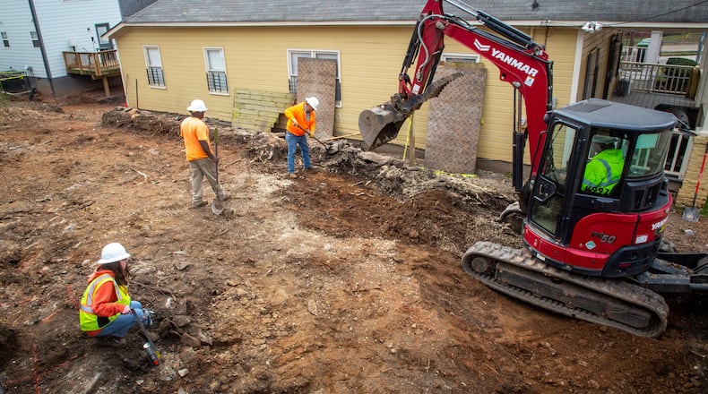 Workers remove dirt from a property that is part of the Westside Lead Superfund site in Atlanta Wednesday, February 2, 2022. STEVE SCHAEFER FOR THE ATLANTA JOURNAL-CONSTITUTION