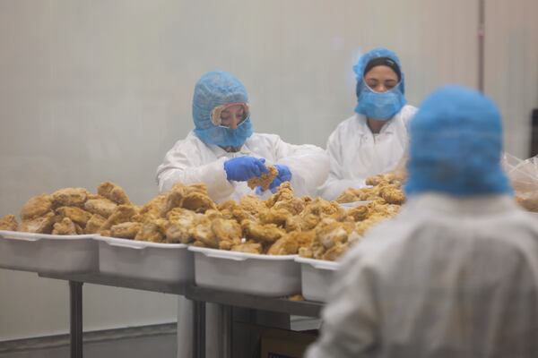 An employee packages chicken in a temperature-controlled room at the Atlanta Community Food Bank, Thursday, May 29, 2025, in East Point, Ga. (Jason Getz/AJC)
