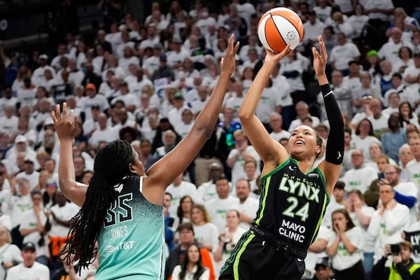 FILE - Minnesota Lynx forward Napheesa Collier (24) shoots over New York Liberty forward Jonquel Jones (35) during the second half in Game 3 of a WNBA basketball final playoff series, Wednesday, Oct. 16, 2024, in Minneapolis. (AP Photo/Abbie Parr, File)