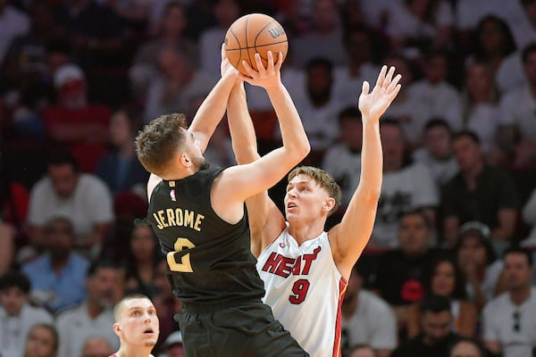 Cleveland Cavaliers guard Ty Jerome (2) shoots over Miami Heat guard Pelle Larsson (9) during the first half in Game 3 of an NBA basketball first-round playoff series, Saturday, April 26, 2025, in Miami. (AP Photo/Michael Laughlin)