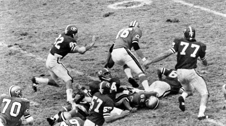 Bill Stanfill (77) was an All-American defensive tackle at UGA, and later became an All-Pro with the NFL’s Miami Dolphins. Here he causes chaos against Georgia Tech during a Bulldogs’ victory in 1960s.