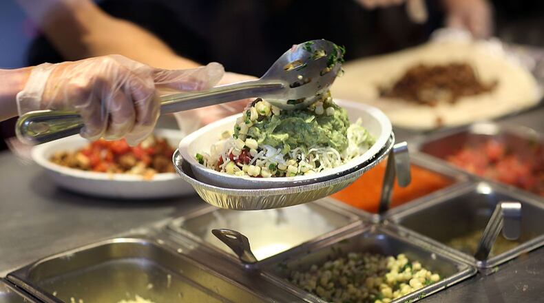 MIAMI, FL - APRIL 27: Chipotle restaurant workers fill orders for customers on the day that the company announced it will only use non-GMO ingredients in its food on April 27, 2015 in Miami, Florida. The company announced, that the Denver-based chain would not use the GMO's, which is an organism whose genome has been altered via genetic engineering in the food served at Chipotle Mexican Grills. (Photo by Joe Raedle/Getty Images)