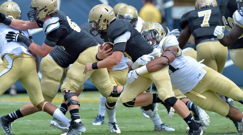 August 30, 2014 Atlanta - Wofford Terriers quarterback Evan Jacks (3) gets tackled from behind by Georgia Tech Yellow Jackets defensive lineman Patrick Gamble (91) in the first half of the Georgia Tech season opener at Bobby Dodd Stadium on Saturday, August 30, 2014. HYOSUB SHIN / HSHIN@AJC.COM