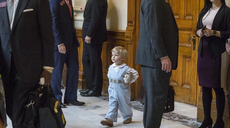 Two-year-old James Gambill of Cartersville navigates his way through Georgia lawmakers as he waits for his father, state Rep. Matthew Gambill, to be sworn in Monday during this year’s first session of the Georgia House. (ALYSSA POINTER/ALYSSA.POINTER@AJC.COM)