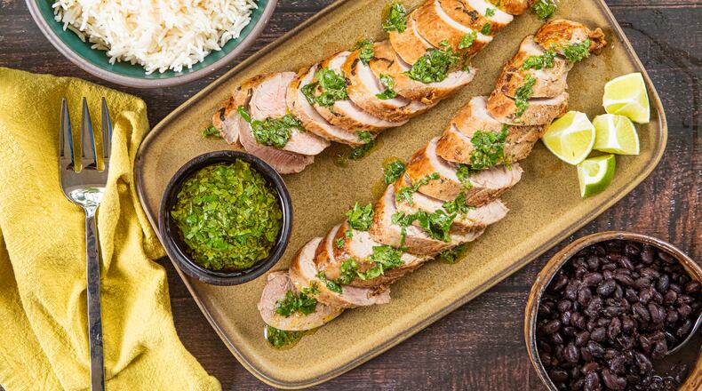 The bright herbs in this quick-cooking mojo-marinated pork tenderloin recipe offer a refreshing alternative to traditional Thanksgiving flavors. (Aaliyah Man for the AJC; food styling by Kate Williams)