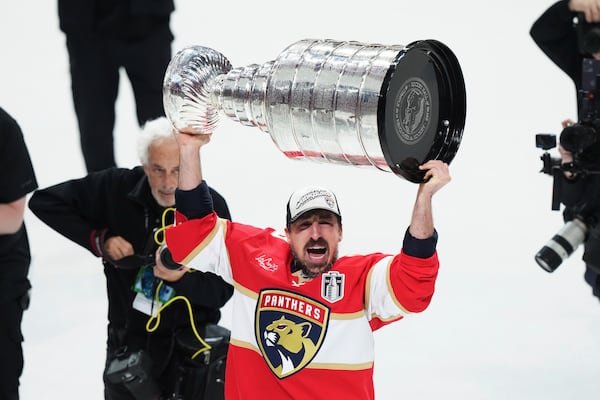 Florida Panthers' Brad Marchand (63) raises the Stanely Cup after defeating the Edmonton Oilers in Game 6 of the NHL hockey Stanley Cup Final in Sunrise, Fla., Tuesday, June 17, 2025. (Nathan Denette/The Canadian Press via AP)