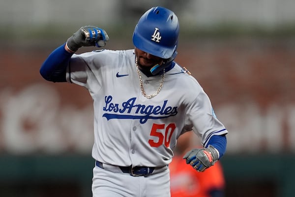 Los Angeles Dodgers' Mookie Betts (50) celebrates his solo homer against the Atlanta Braves in the sixth inning of a baseball game, Friday, May 2, 2025, in Atlanta. (AP Photo/Mike Stewart)