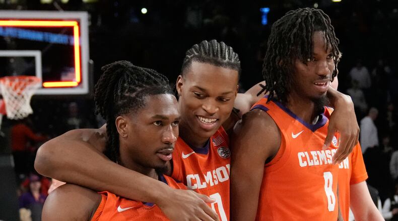 Clemson's guard Jestin Porter (1) forward RJ Godfrey (0) and forward Dallas Thomas (8) react after a win after an NCAA college basketball game against Georgia Tech, Saturday, Jan. 24, 2026, in Atlanta. (AP Photo/Brynn Anderson)