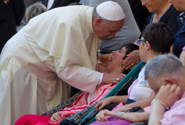FILE - Pope Francis blesses sick and disabled people at the end of a pro-life Mass in St. Peter's Square, at the Vatican, Sunday, June 16, 2013. (AP Photo/Andrew Medichini, file)