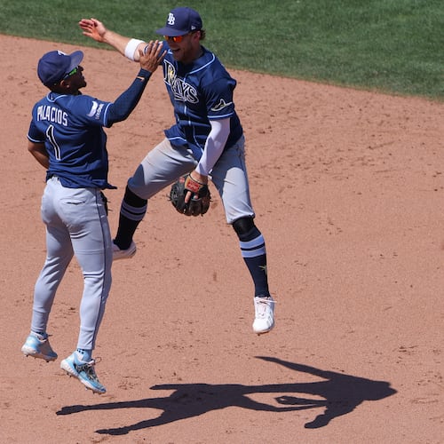 Tampa Bay Rays' Richie Palacios (1) and Taylor Walls, right, celebrate after the final out of a baseball game as the Rays defeat the Athletics Wednesday, Aug. 12, 2026, in West Sacramento, Calif. (AP Photo/Scott Marshall)
