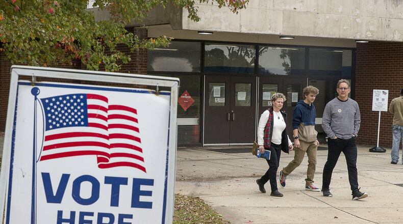Jeff Brown (right), his wife Melony Brown (left) and their son Palmer Brown, leave Campbell Middle School after Jeff and Melony casted their ballots during Election Day in Smyrna, Tuesday, November 5, 2019. (Alyssa Pointer/Atlanta Journal Constitution)
