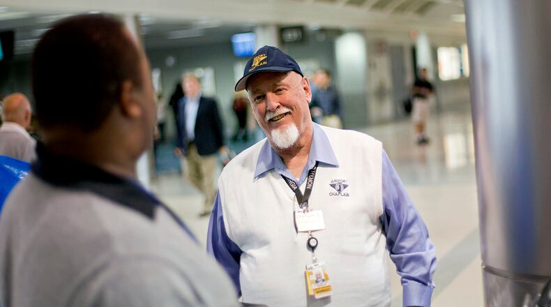 Airport chaplain Rev. Frank Colladay Jr., right, talks with airport worker Lance Norris as he makes his rounds through a concourse at Hartsfield-Jackson International Airport.