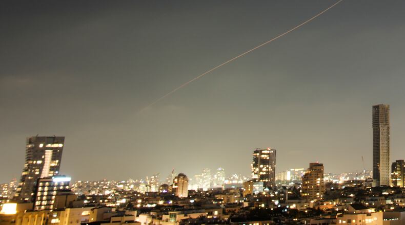 A projectile streaks through the sky over central Israel during an Iranian missile attack, Sunday, June 7, 2026. (AP Photo/Ohad Zwigenberg)