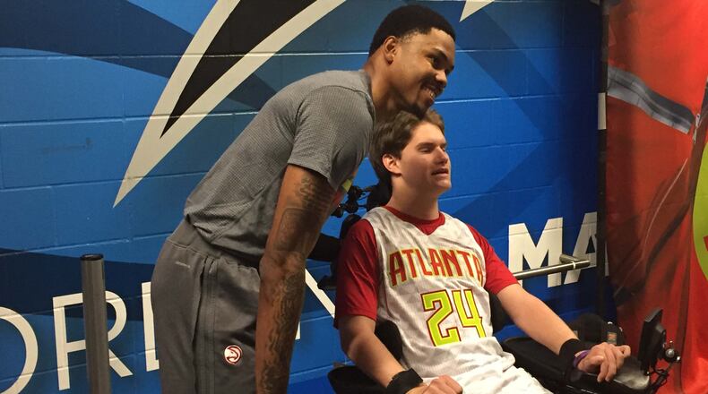 Kent Bazemore meets with John Michael Night before Saturday’s game in Orlando. Photo by Chris Vivlamore